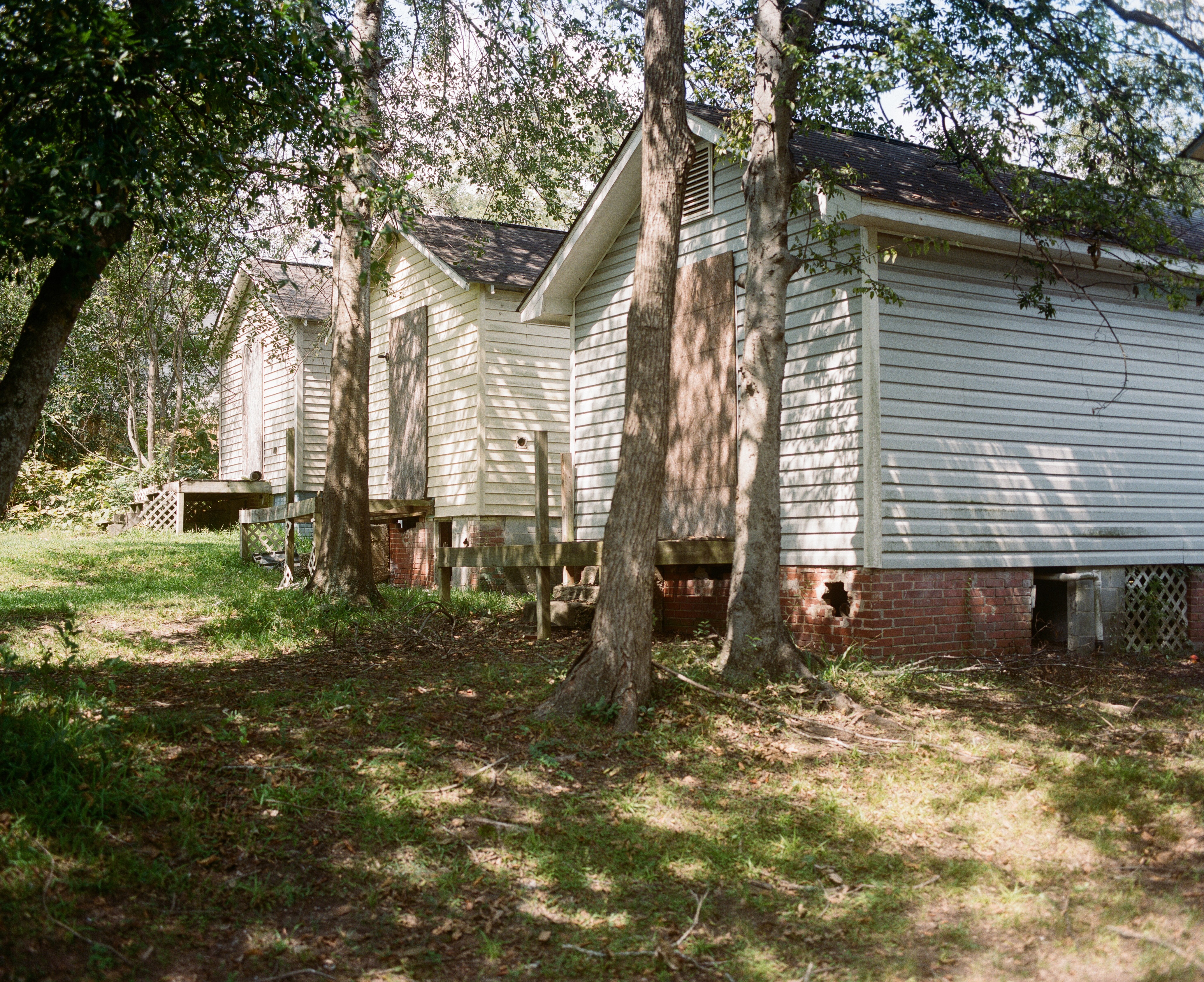 back of three shotgun homes